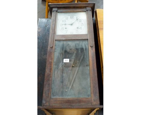 A 1930's striking wall clock in oak and glazed case 