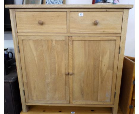 A modern light oak side board, with two drawers and cupboards 3' wide