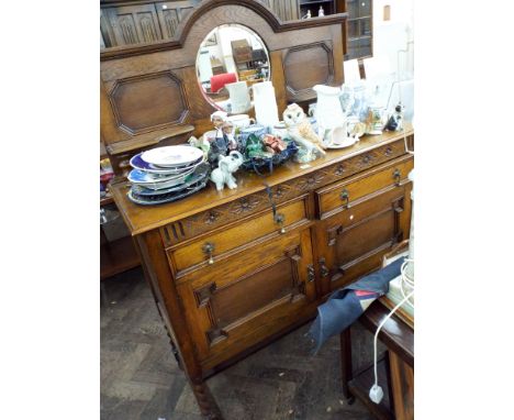 A 1930's oak sideboard with circular mirror back standing on barley twist legs 4' wide 