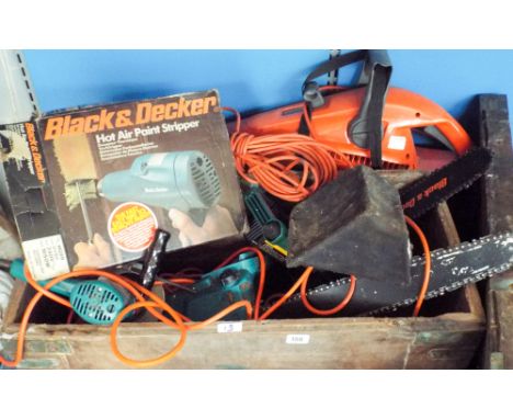 A large box of tools, electric chainsaws, an old wooden box etc