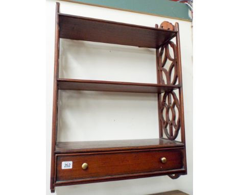 A reproduction mahogany three tier wall shelf, fitted drawer, 21" wide