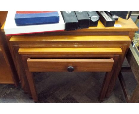 A nest of three 1970's teak coffee tables the smallest one with fitted draw 