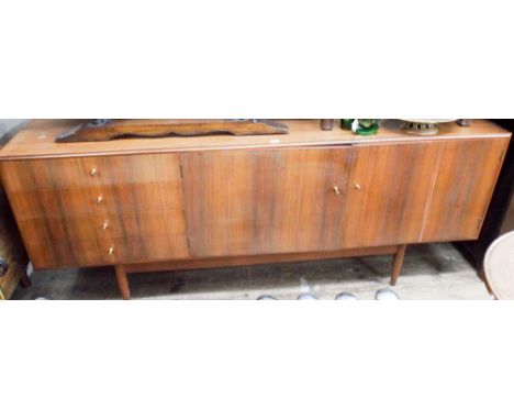 1960's long low teak sideboard, fitted cupboards and four drawers, 6' 6" wide, 33" high. 