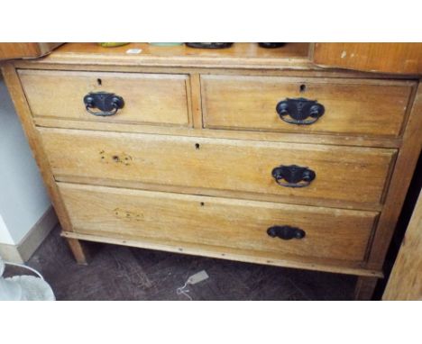 A light oak chest of two long and two short drawers (no handles)