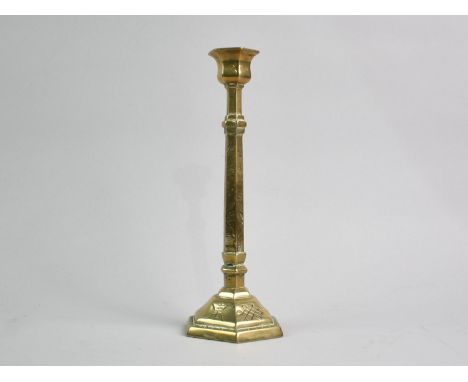 A Far Eastern Brass Candlestick with Engraved Decoration, 25cms High
