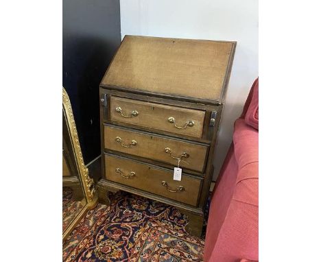 An Edwardian mahogany bureau of small proportions, fall front enclosing a fitted interior above three drawers raised on brack