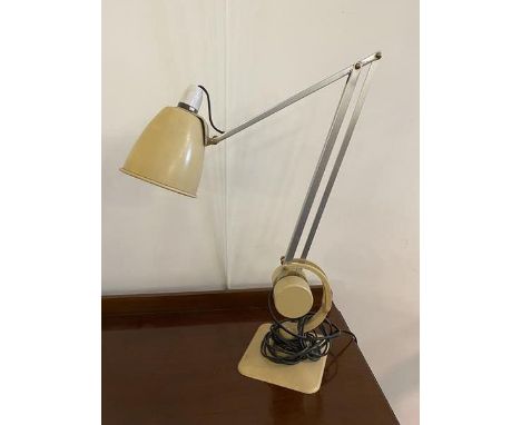 A latter half of 20thc adjustable desk lamp with conical shade on polished metal supports, painted base and circular counter 