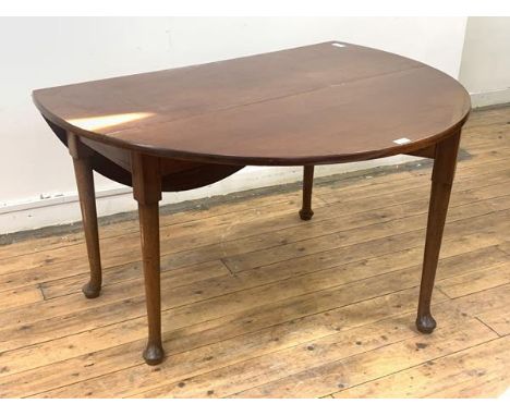A George III mahogany gate leg drop leaf dining table, oval top raised on turned supports with pad feet, (72cm x 124cm x 136c