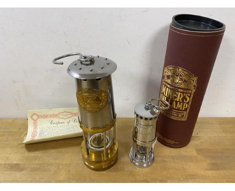 A Cambrian safety lamp in presentation canister along with certificate of origin, (26cm high), and a second of smaller size (