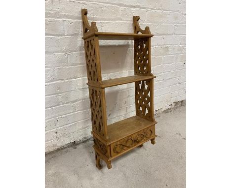 A hanging shelf with two shelves on pierced sides with drawer to base, (98cm x 41cm x 16cm)