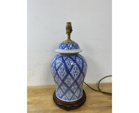 A modern blue and white baluster shaped lidded jar matching previous lot, converted to table lamp, on pierced wooden base, (4