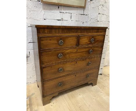 A Georgian chest of drawers, the inlaid rectangular top over two short drawers and three graduated long drawers, with drop ri
