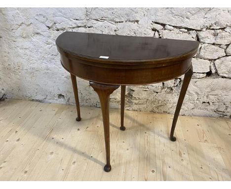 A Georgian style mahogany and walnut demi lune card table, c1930, fold-over top with baize lined playing surface above plain 