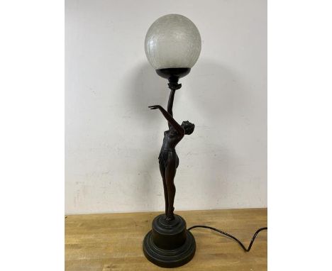An Art Deco style table lamp in the form of a lady holding a frosted circular shade, composition, inscribed 1994 to base, (66