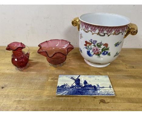 A mixed lot including a cranberry glass water jug (11cm high), and a cranberry glass footed bowl, a delft tile and a cash pot