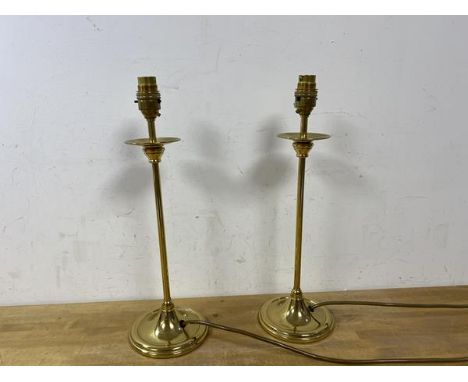 A pair of brass candlestick style tablelamps raised on circular bases, (measures 40cm to top of lampholder)