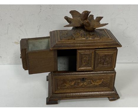 A c1900's Swiss treen jewellery box, the hinged lid with two doves, opens to two fold out compartments over single compartmen
