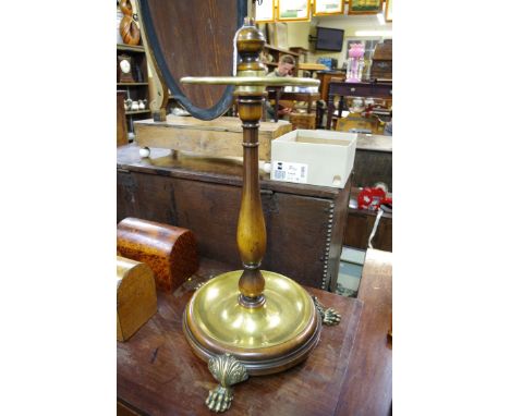 An unusual mahogany and brass circular stick stand, on paw feet, 60cm high.&nbsp; 