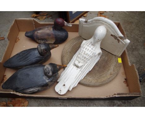 Three painted wood decoy ducks; together with a parrot wall bracket; and an oak bread board. 