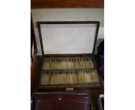 A case of microscope slides, approx 50 with specimens.&nbsp; 