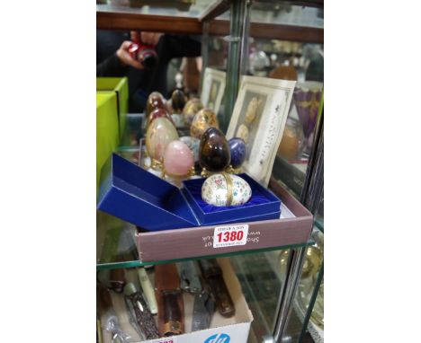 A Halcyon Days enamel egg, boxed; together with a cloisonne egg; and other hard stone eggs. 