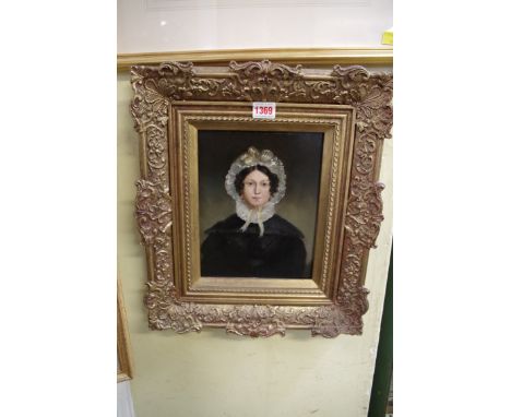 British School, 19th century, bust length portrait of a young woman with a lace bonnet, oil on canvas laid on board, 23.5 x 1