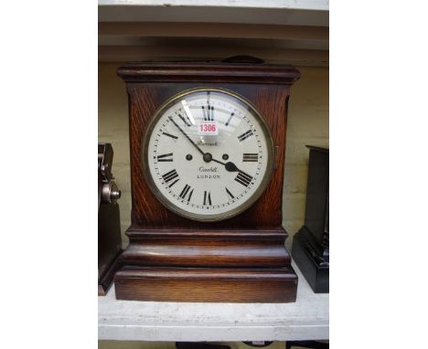 An oak mantel clock, the repainted dial inscribed 'Barrauds, Corn Hill, London', with twin fusee movement, 40.5cm high, with 