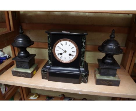 A slate and marble mantel clock,&nbsp;22cm high; together with a pair of slate and green onyx side urns.&nbsp; 
