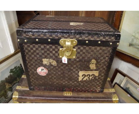 A vintage Louis Vuitton canvas and metal bound trunk, circa 1890, with houndstooth chequered decoration, the interior with pa