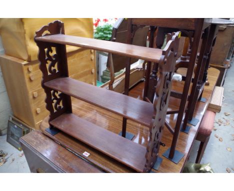 A mahogany hanging wall shelf,&nbsp;with pierced ends, 63cm wide.&nbsp; 