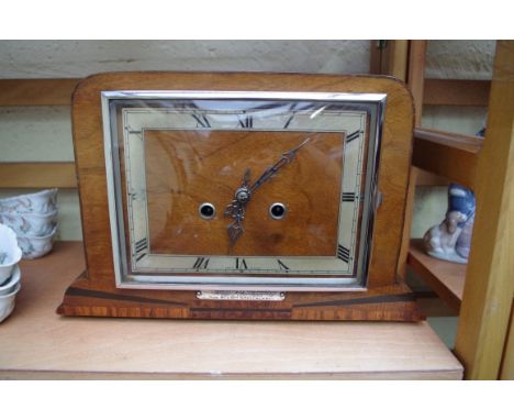 A 1930s walnut mantel clock,&nbsp;33cm wide, (lacking pendulum bob). 