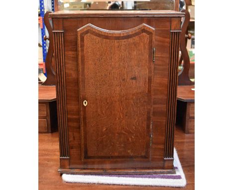 A 19th Century Crossbanded Mahogany and Oak Small Cupboard, with reeded quarter columns, 45cm by 20cm by 62cmThis is the cent