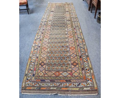 Sarab Runner, the camel ground with rows of stylised boteh and animals enclosed by multiple narrow borders, 395cm by 113cmPro