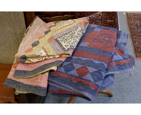 A Late 19th Century Indian Blue Ground Patchwork Bed Cover of trellis design enclosing squares of floral design within a geom