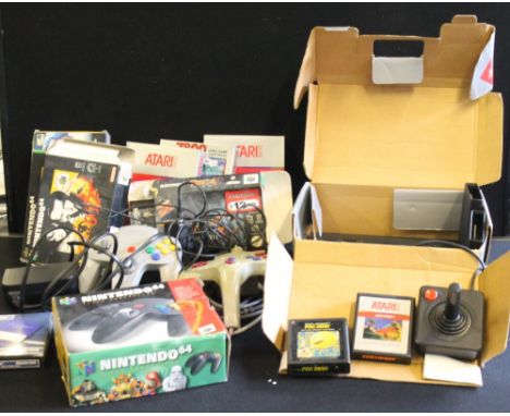 ATARI - NINTENDO - a boxed Atari 2600 with original Atari joystick and 7 games, a boxed Nintendo 64 controller, 4 Nintendo 64
