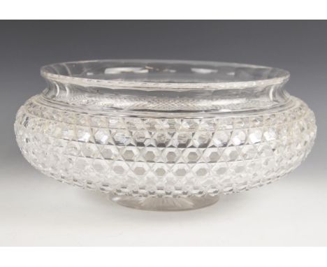 A hobnail cut glass bowl of large proportions, 20th century, of squat form with flared faceted rim, raised on a short column 