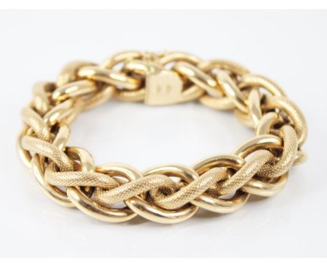 A continental 18ct gold curb link bracelet, designed as entwined plain polished and textured curb links, tongue and box snap 