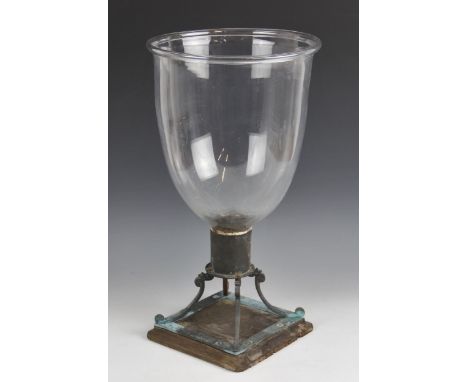 A glass storm candle lamp, late 19th/early 20th century, of typical inverted bell form with integrated candle holder to the i