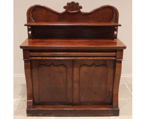 A Victorian mahogany chiffonier, the shaped raised back with a leafy crest over a single shelf raised upon 'S' shaped support