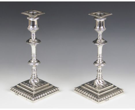 A pair of George III silver candlesticks, hallmarked I.W (possibly John Weldring or James Wibird), London 1768, each upon wei