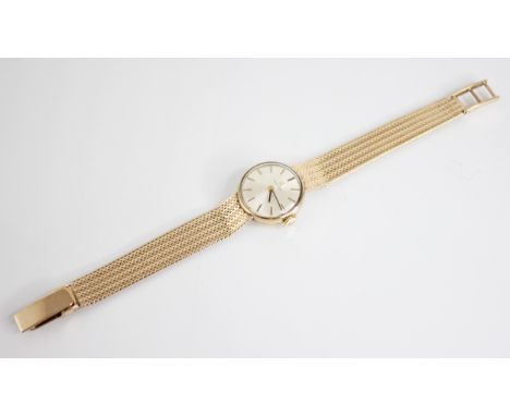 A lady’s vintage 9ct gold Tissot wristwatch, round pearlescent dial with baton markers, set to a plain polished case, 20mm di