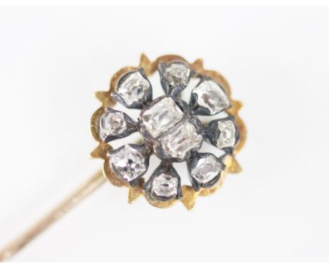 A 19th century diamond flower head stick pin, comprising two central rectangular cushion cut diamonds with a surround of eigh