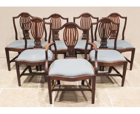 A well matched set of twelve mahogany Hepplewhite style dining chairs, to include a set of seven George III chairs and five f