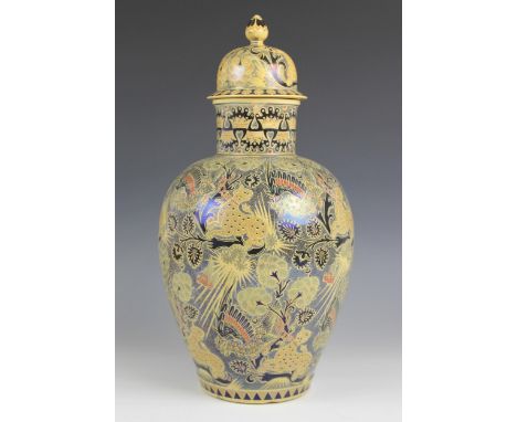 An unusual Zsolnay Pecs vase and cover, Hungary early 20th century, the busily decorated ground depicting cheetah's and exoti