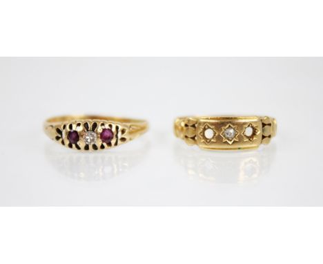 An early 20th century diamond and ruby set 18ct gold ring, designed as a central round mixed cut diamond flanked by a mixed c