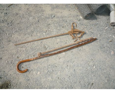 A steel-yard weighing device, a wood auger and a walking stick.