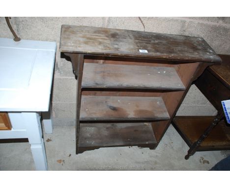 A dark wood three shelf bookcase.