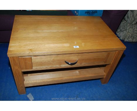 A coffee table with drawer and lower shelf.