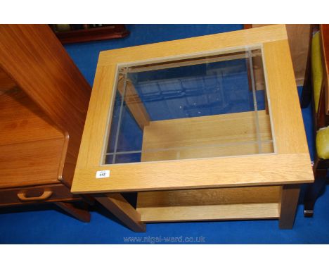 A contemporary square Pine coffee Table with glass insert to top and lower shelf.