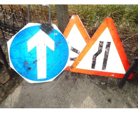 Two narrow lane signs and a blue arrow sign.